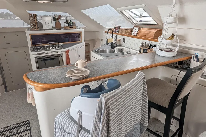 Slide: The Image of Cozy kitchen interior of 2001 Voyage 440 yacht with modern amenities and natural light. - 6