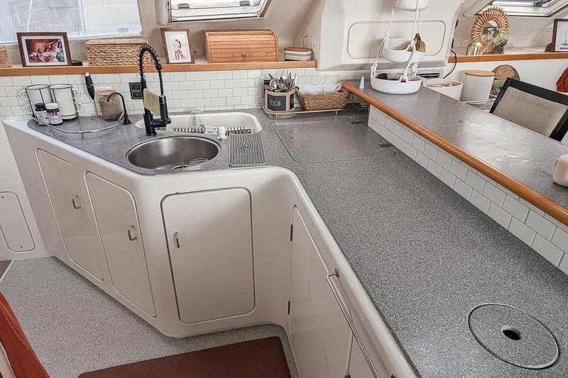 Slide: The Image of Modern kitchen interior of 2001 Voyage 440 yacht with sleek countertops and sink. - 7