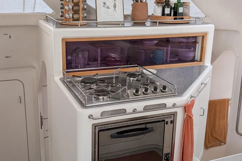 Slide: The Image of Compact kitchen area in a 2001 Voyage 440 yacht with stove and oven. - 8