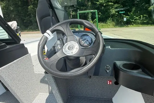 Slide: The Image of Steering wheel and dashboard of 2026 Crestliner 1650 Kodiak boat, featuring modern controls. - 5