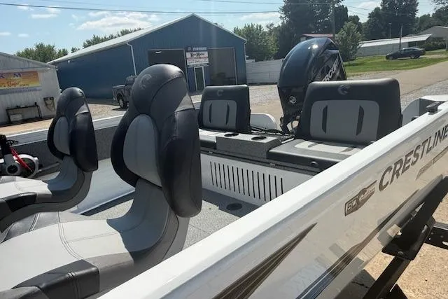 Slide: The Image of 2026 Crestliner 1650 Kodiak boat with seating and motor, parked outdoors. - 7