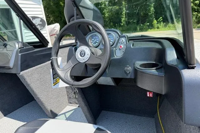 Slide: The Image of 2026 Crestliner 1650 Kodiak boat interior with steering wheel and dashboard controls. - 5