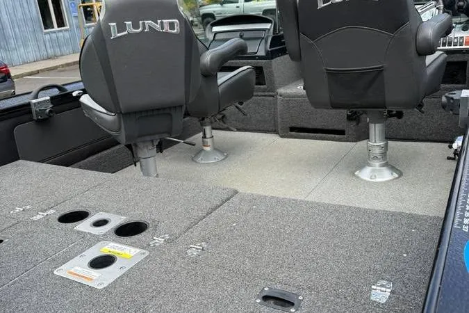 Slide: The Image of 2020 Lund 1875 Pro-V Sport boat interior with swivel seats and carpeted deck. - 11