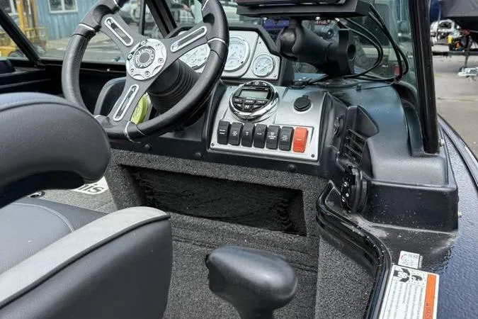 Slide: The Image of 2020 Lund 1875 Pro-V Sport boat dashboard with steering wheel and control panel. - 15