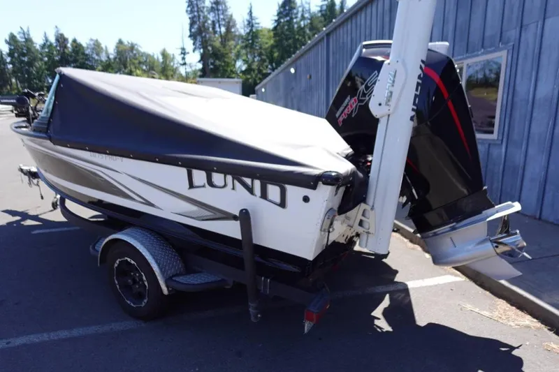 Slide: The Image of 2020 Lund 1875 Pro-V Sport boat on trailer, covered and parked outdoors. - 17