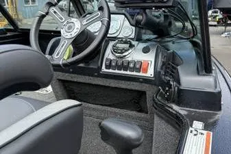 Slide: The Image of 2020 Lund 1875 Pro-V Sport boat dashboard with steering wheel and control panel. - 20