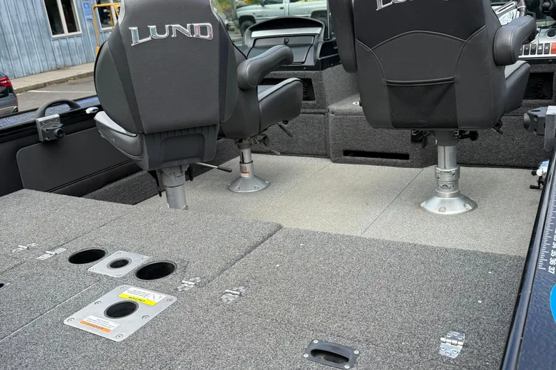 Slide: The Image of 2020 Lund 1875 Pro-V Sport boat interior with swivel seats and carpeted deck. - 6