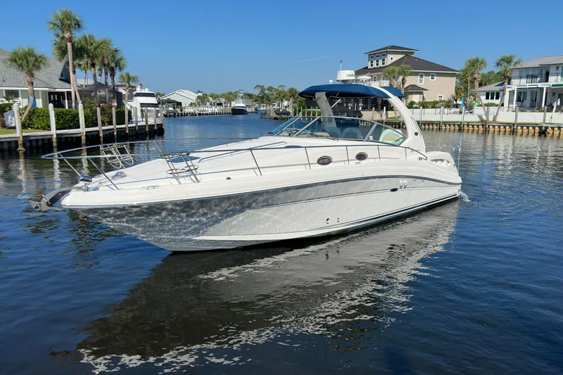 The Image of 2008 Sea Ray 340 Sundancer yacht cruising in a scenic waterfront area. - 0