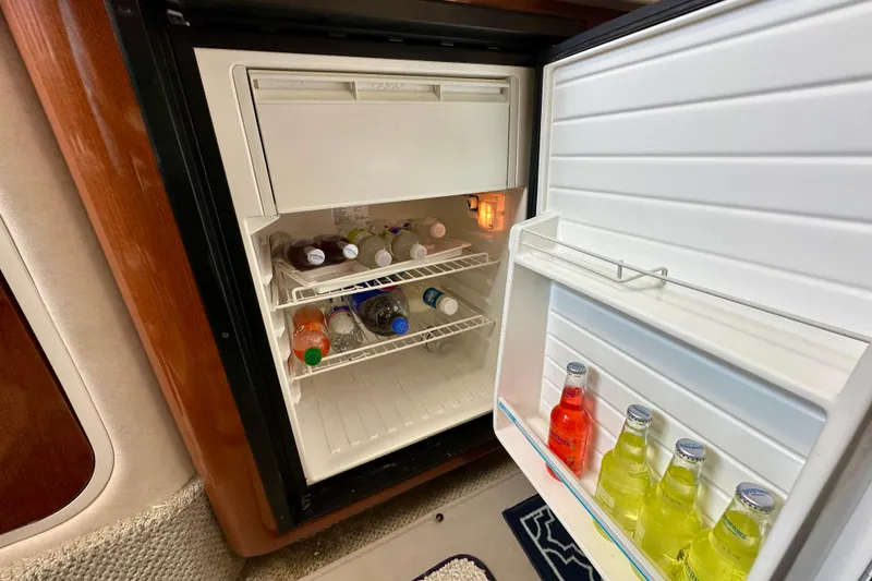 Slide: The Image of Mini fridge stocked with beverages inside a 2008 Sea Ray 340 Sundancer yacht. - 101