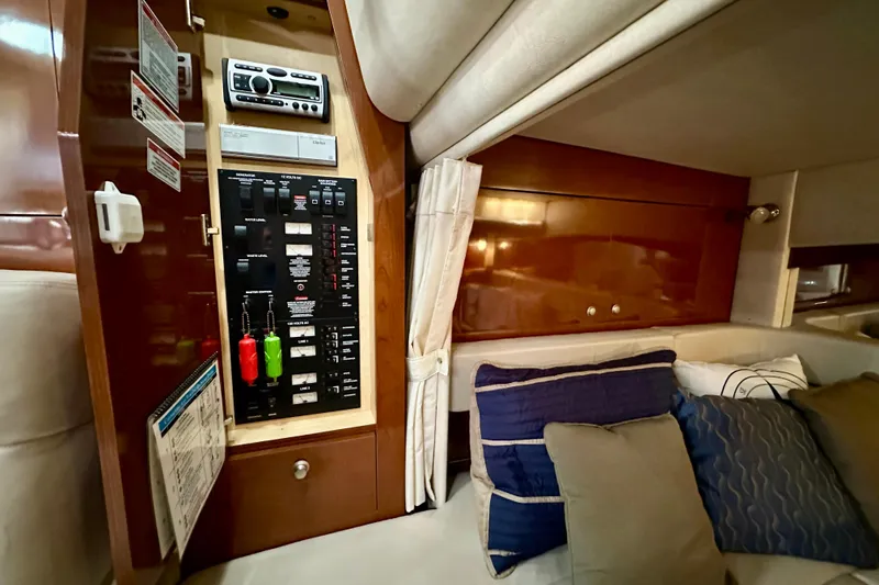Slide: The Image of 2008 Sea Ray 340 Sundancer cabin interior with control panel and cozy seating area. - 102