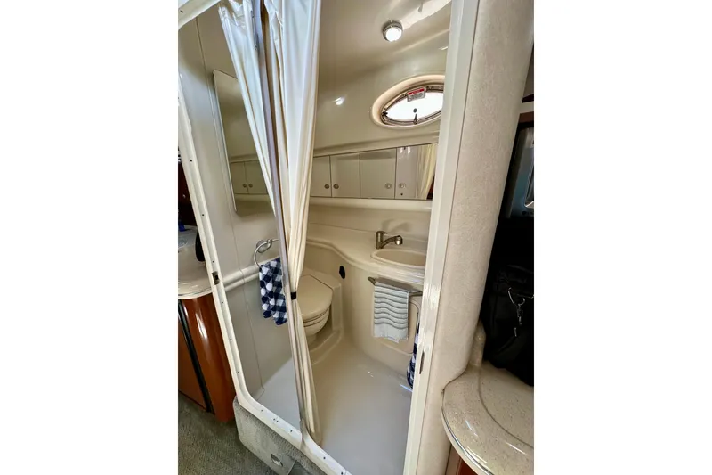 Slide: The Image of 2008 Sea Ray 340 Sundancer bathroom with shower, sink, and storage cabinets. - 103