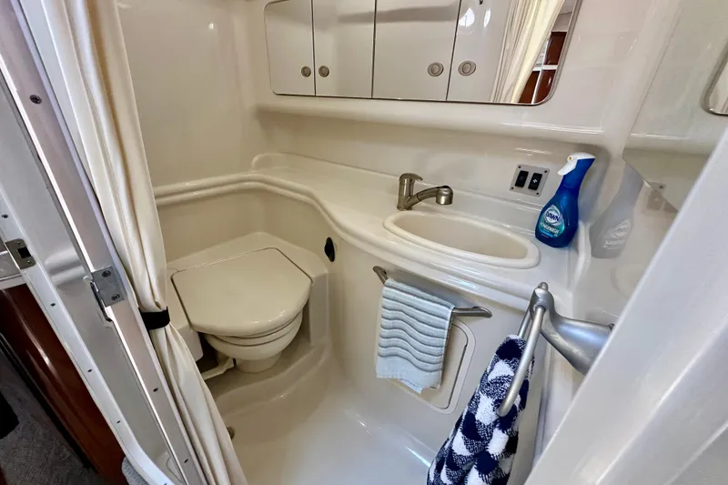Slide: The Image of Compact bathroom in 2008 Sea Ray 340 Sundancer yacht with sink, toilet, and storage cabinets. - 106