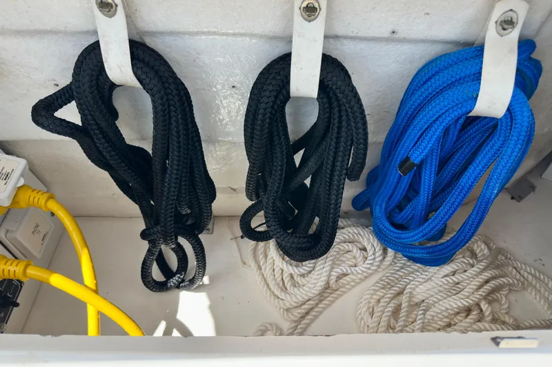 Slide: The Image of Coiled ropes and cables in a 2008 Sea Ray 340 Sundancer storage compartment. - 107