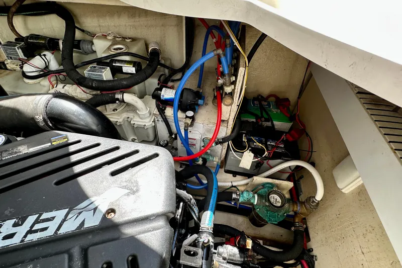 Slide: The Image of Engine compartment of a 2008 Sea Ray 340 Sundancer with visible wiring and components. - 129