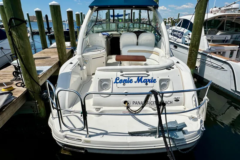 Slide: The Image of 2008 Sea Ray 340 Sundancer docked at marina, rear view with seating area. - 17