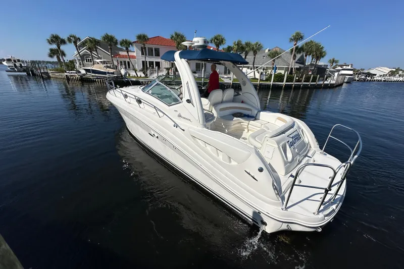 Slide: The Image of 2008 Sea Ray 340 Sundancer yacht docked in a scenic marina setting. - 2