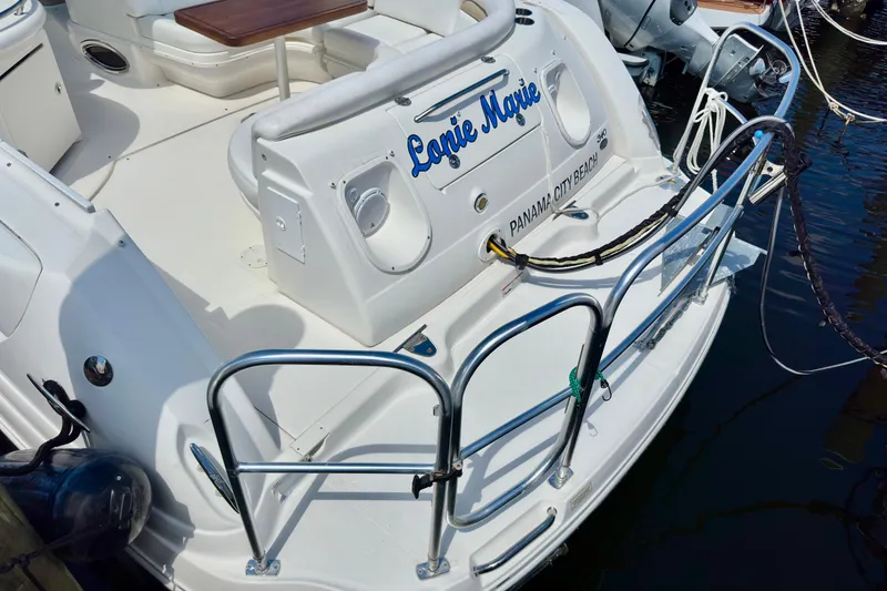 Slide: The Image of 2008 Sea Ray 340 Sundancer boat docked, featuring a spacious deck and seating area. - 23