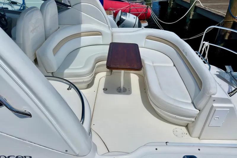 Slide: The Image of 2008 Sea Ray 340 Sundancer boat with white seating and wooden table on deck. - 25