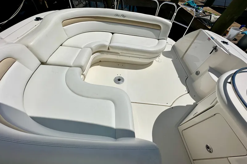 Slide: The Image of 2008 Sea Ray 340 Sundancer boat interior with white seating and storage compartments. - 27