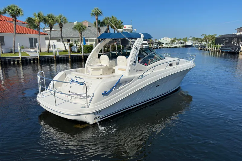 Slide: The Image of 2008 Sea Ray 340 Sundancer yacht cruising in a sunny canal with palm trees. - 3