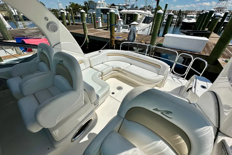 Slide: The Image of 2008 Sea Ray 340 Sundancer yacht interior with white seating at marina. - 30
