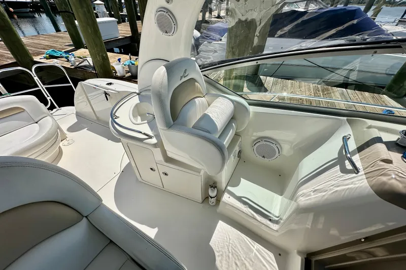 Slide: The Image of 2008 Sea Ray 340 Sundancer cockpit with white seating and helm, docked at marina. - 31