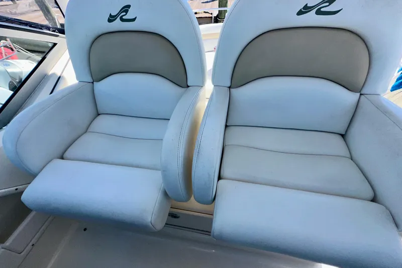 Slide: The Image of 2008 Sea Ray 340 Sundancer boat seats, white and beige upholstery, with logo detail. - 35