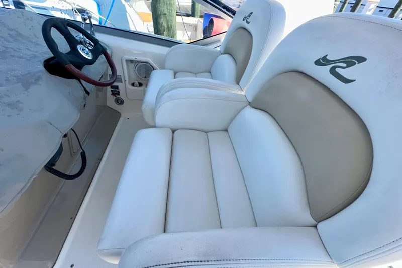 Slide: The Image of 2008 Sea Ray 340 Sundancer cockpit with white leather seats and steering wheel. - 36