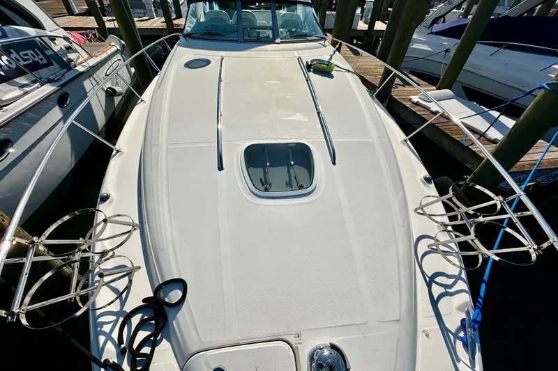 Slide: The Image of 2008 Sea Ray 340 Sundancer yacht docked, showcasing sleek deck design and mooring lines. - 5