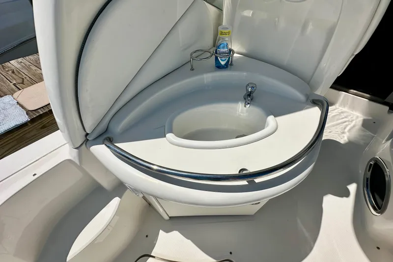Slide: The Image of 2008 Sea Ray 340 Sundancer boat sink with chrome rail and cleaning supplies. - 51