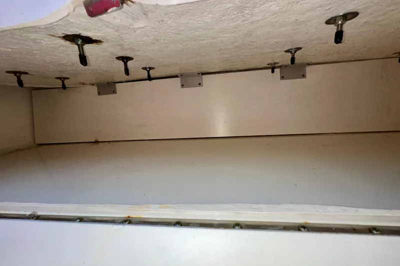 Slide: The Image of Interior compartment of a 2008 Sea Ray 340 Sundancer boat, showing screws and brackets. - 56