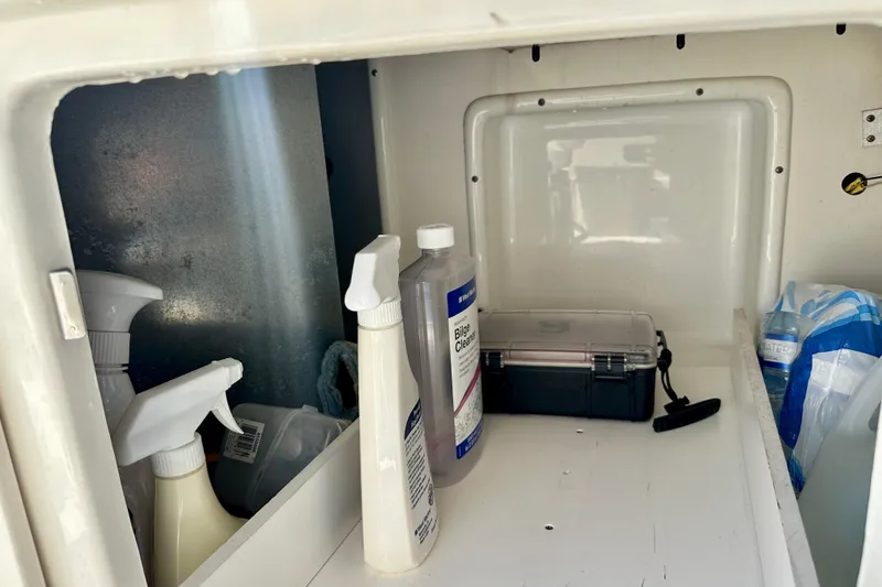 Slide: The Image of Storage compartment on a 2008 Sea Ray 340 Sundancer with cleaning supplies and a toolbox. - 58