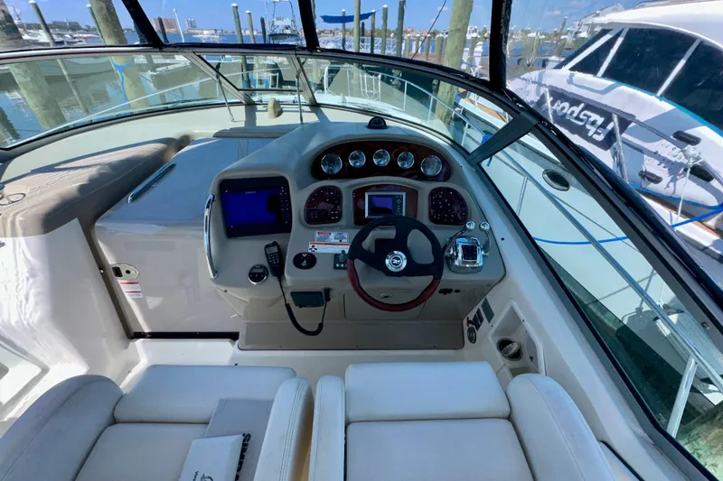 Slide: The Image of 2008 Sea Ray 340 Sundancer helm with modern controls and navigation system. - 59