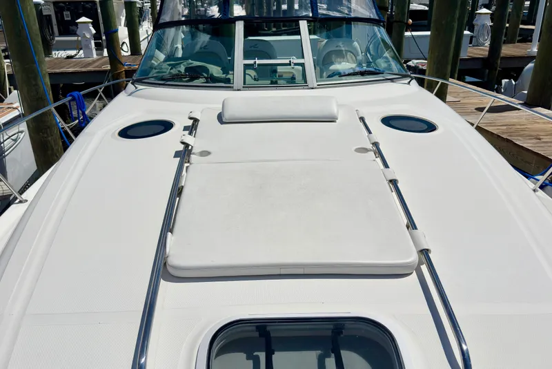 Slide: The Image of 2008 Sea Ray 340 Sundancer boat deck with sunpad and railings at marina. - 6