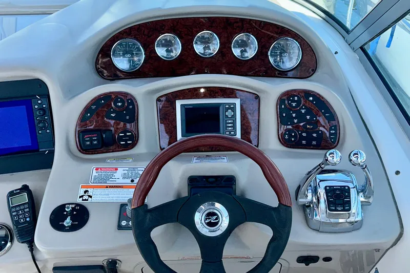 Slide: The Image of 2008 Sea Ray 340 Sundancer helm with gauges, controls, and steering wheel. - 60
