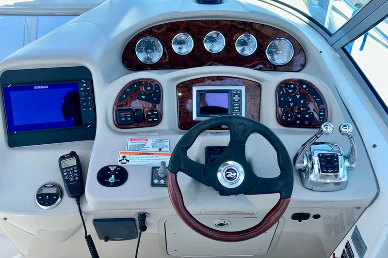 Slide: The Image of Cockpit of 2008 Sea Ray 340 Sundancer with steering wheel and navigation controls. - 61