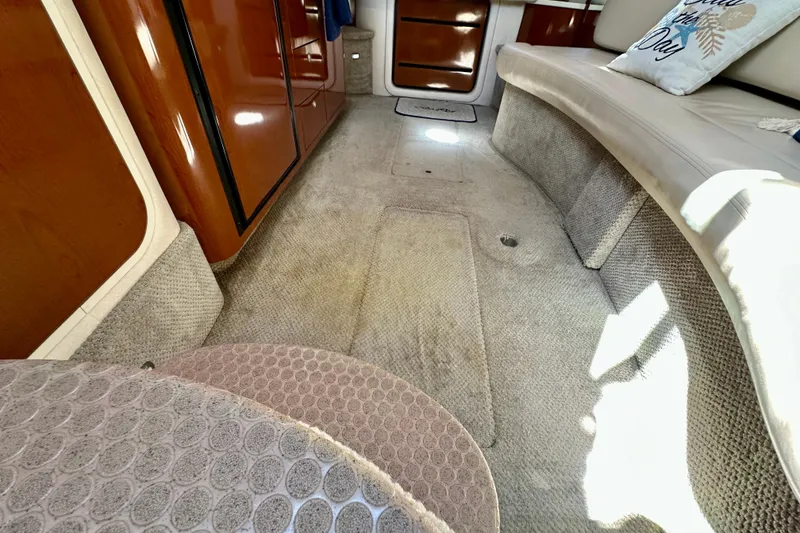 Slide: The Image of Interior of 2008 Sea Ray 340 Sundancer with carpeted flooring and wooden cabinetry. - 73