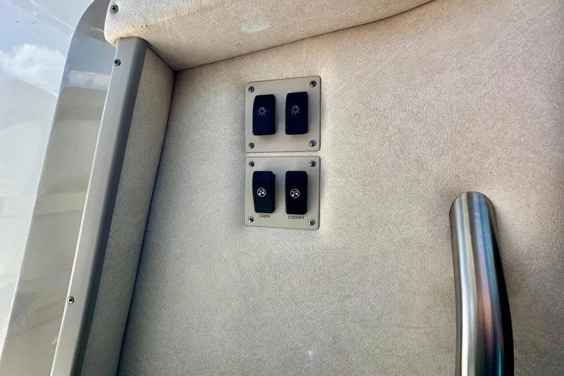 Slide: The Image of Control panel on 2008 Sea Ray 340 Sundancer boat interior with switches and handle. - 75