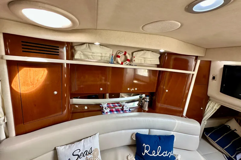 Slide: The Image of Interior of 2008 Sea Ray 340 Sundancer yacht with wooden cabinets and cozy seating. - 79