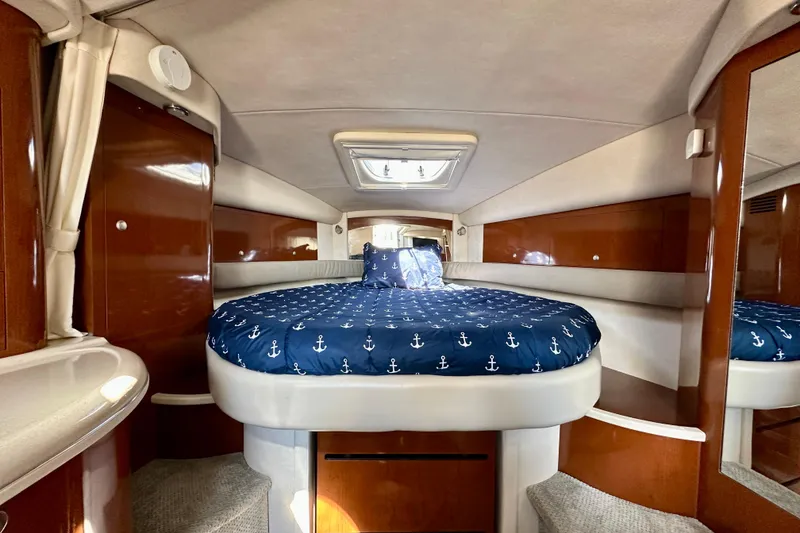 Slide: The Image of 2008 Sea Ray 340 Sundancer cabin interior with nautical-themed bedding. - 82