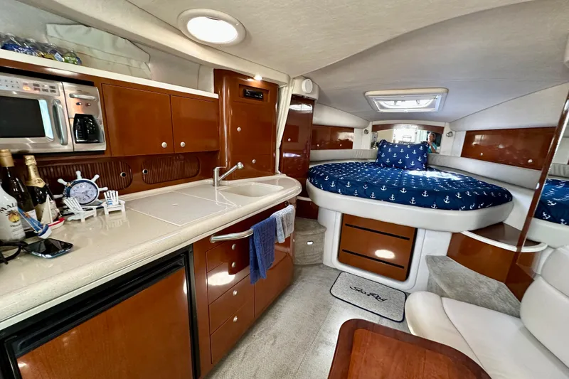 Slide: The Image of Luxurious interior of 2008 Sea Ray 340 Sundancer with kitchenette and cozy sleeping area. - 86