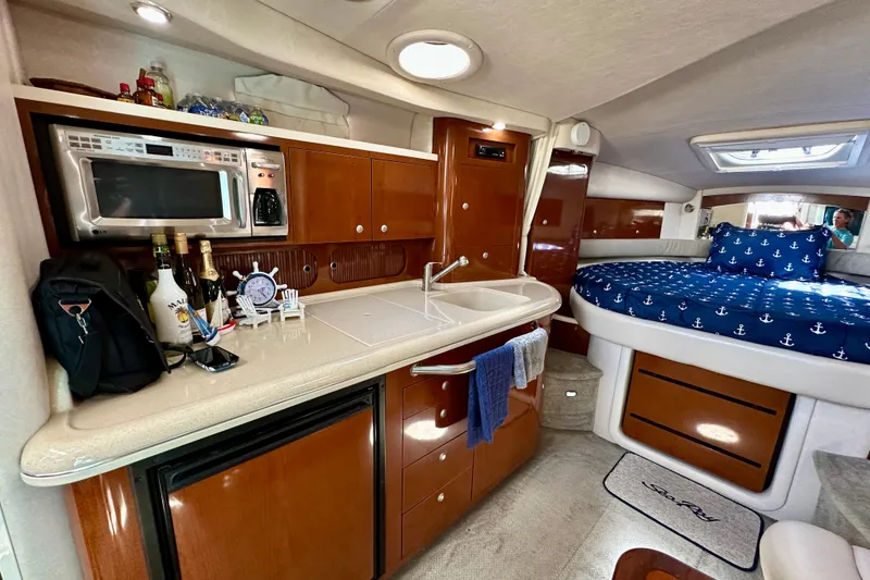Slide: The Image of Interior of 2008 Sea Ray 340 Sundancer with kitchenette and cozy sleeping area. - 87