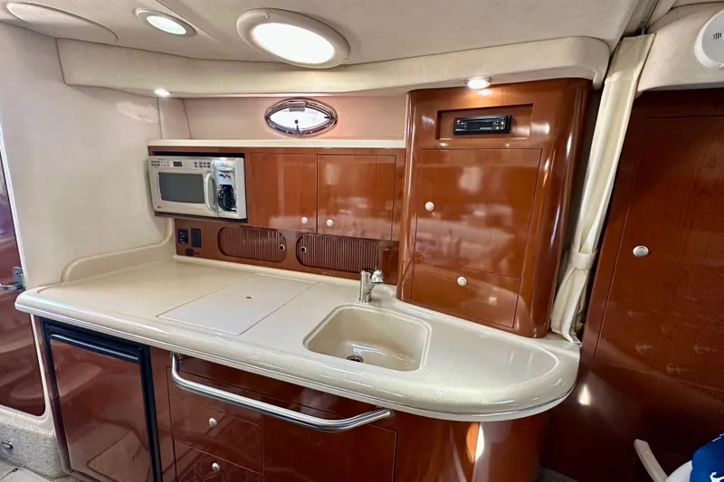 Slide: The Image of 2008 Sea Ray 340 Sundancer interior kitchen with microwave and sink. - 88