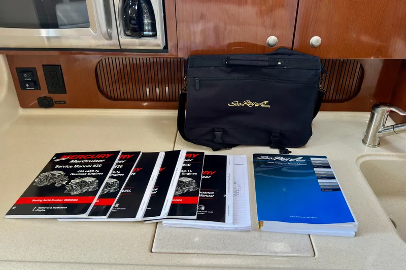 Slide: The Image of Bag and manuals for 2008 Sea Ray 340 Sundancer on a kitchen counter. - 89