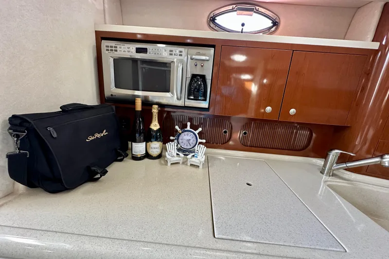 Slide: The Image of Luxurious 2008 Sea Ray 340 Sundancer galley with microwave, wine, and elegant cabinetry. - 91