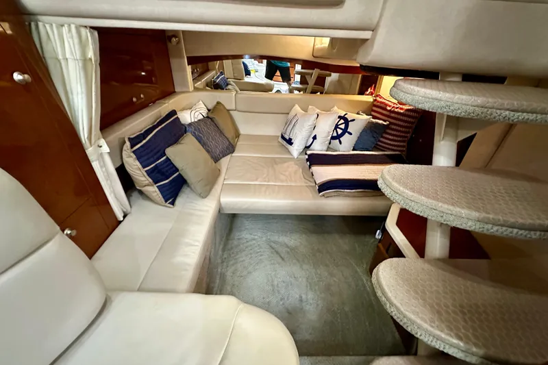 Slide: The Image of Interior of 2008 Sea Ray 340 Sundancer with cozy seating and nautical-themed cushions. - 94