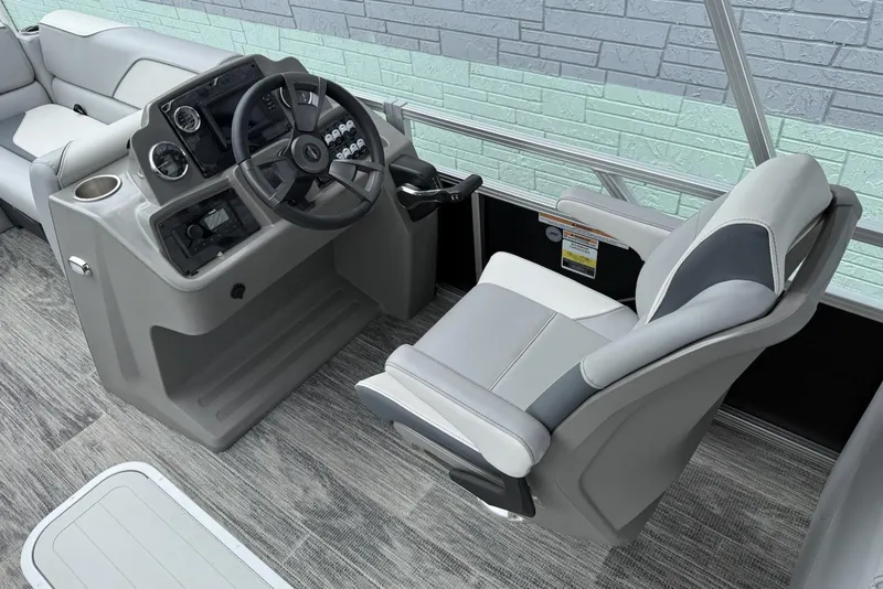 Slide: The Image of 2025 Avalon Venture Quad Lounger 2180 boat interior with steering console and captain's chair. - 8
