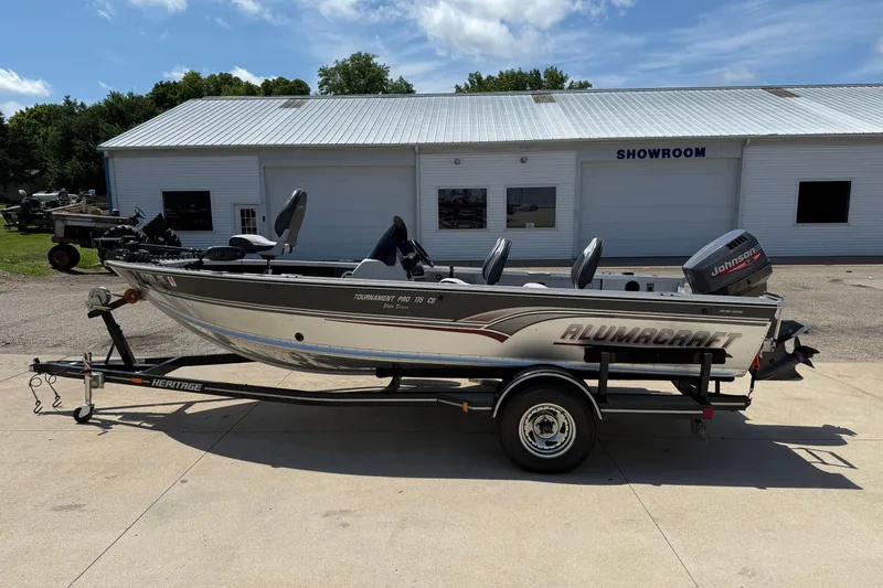 Slide: The Image of 1999 Alumacraft Tournament Pro 175 CS boat on trailer outside showroom. - 1
