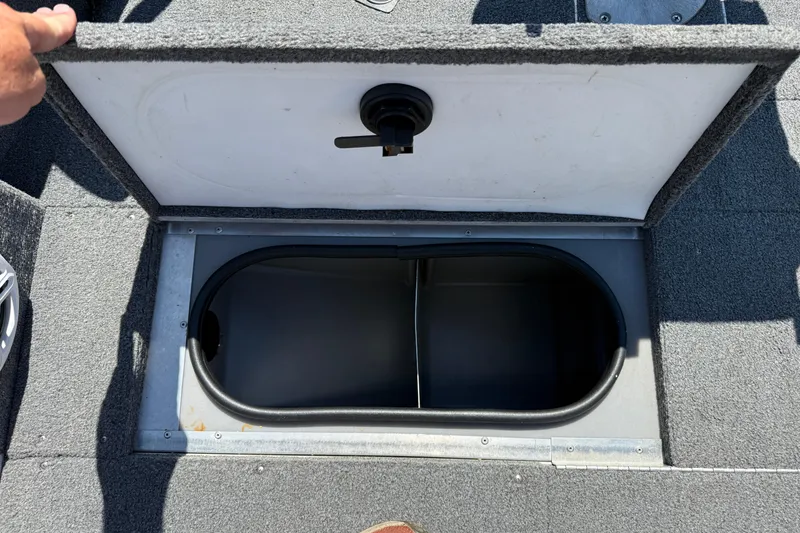Slide: The Image of Open storage compartment on 1999 Alumacraft Tournament Pro 175 CS boat deck. - 13