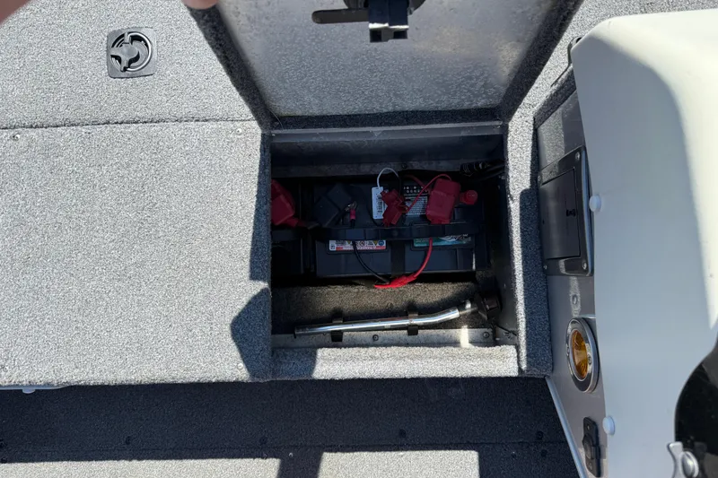 Slide: The Image of 1999 Alumacraft Tournament Pro 175 CS boat battery compartment with visible wiring. - 14